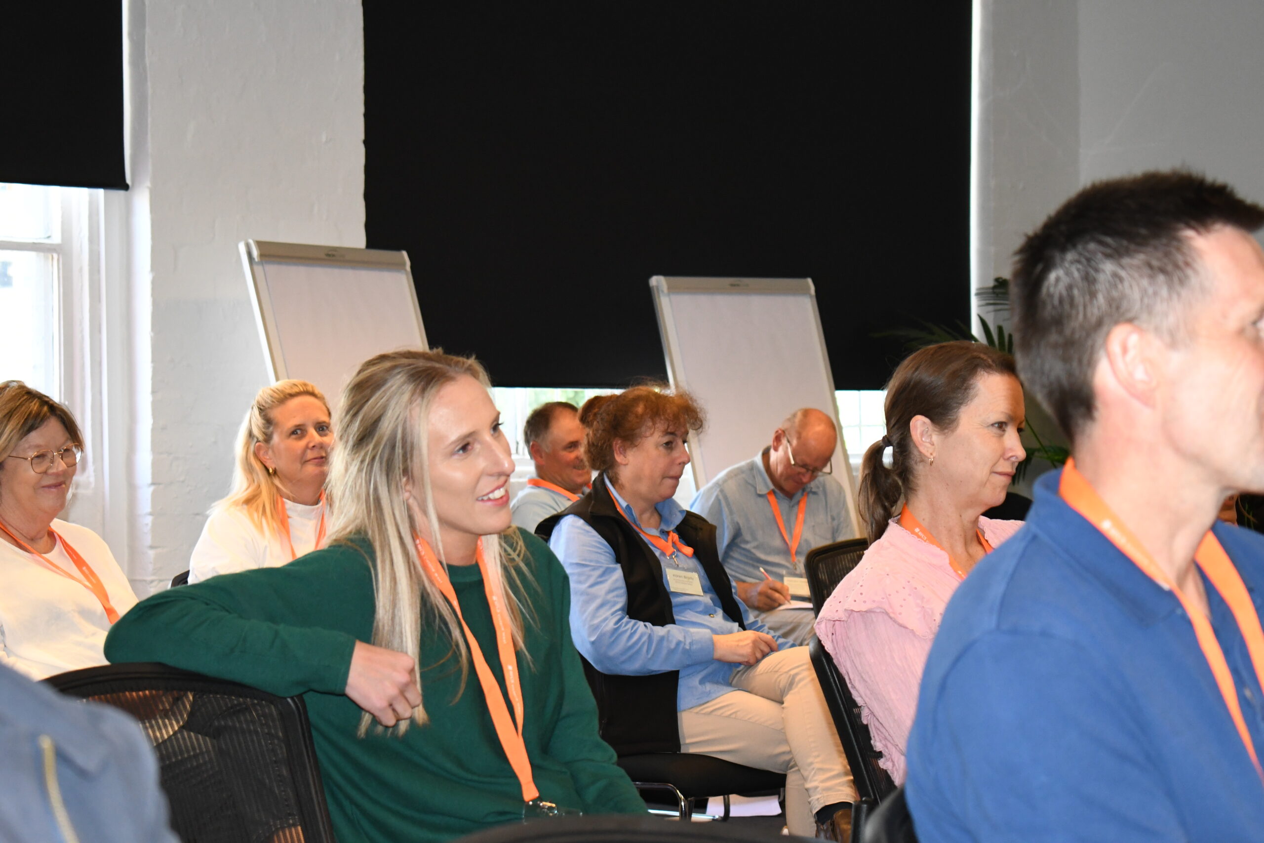A group of people sit in the audience of a conference in Melbourne,